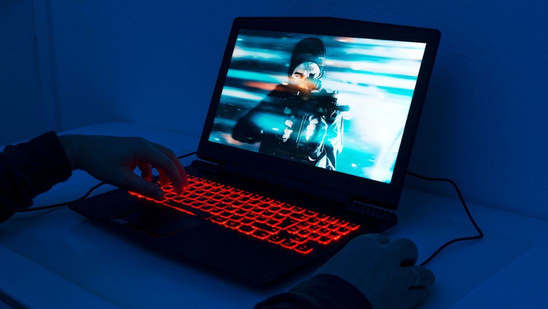 man playing a game on a laptop